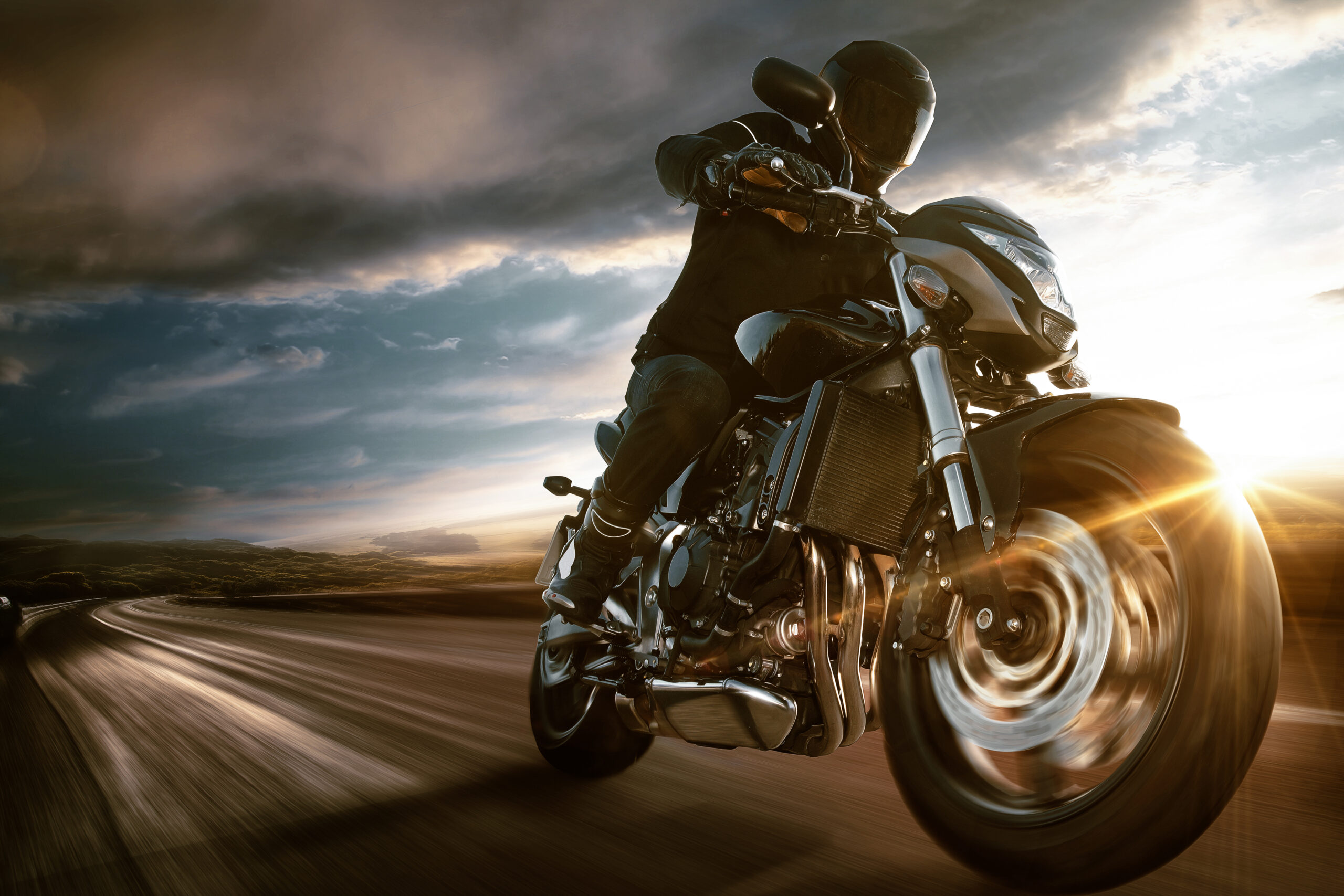 person riding a motorcycle while wearing full protective gear