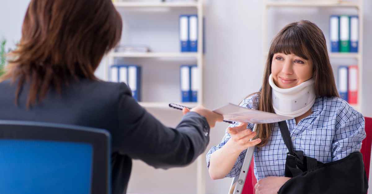 An injured woman meeting with an attorney